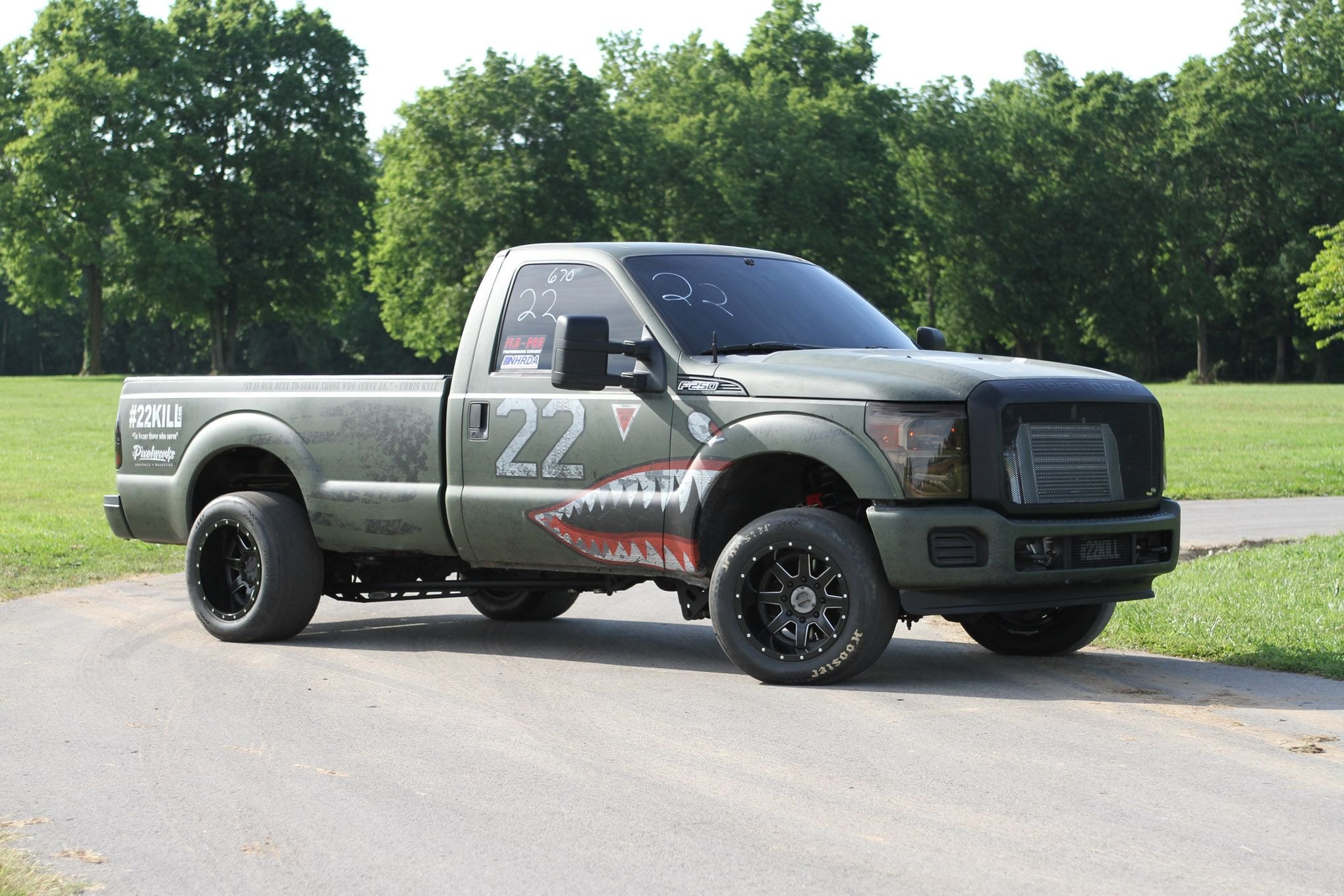Green Lifted Ford F-250 with Aftermarket Dark Smoke Headlights - Photo by Adam Dobbs