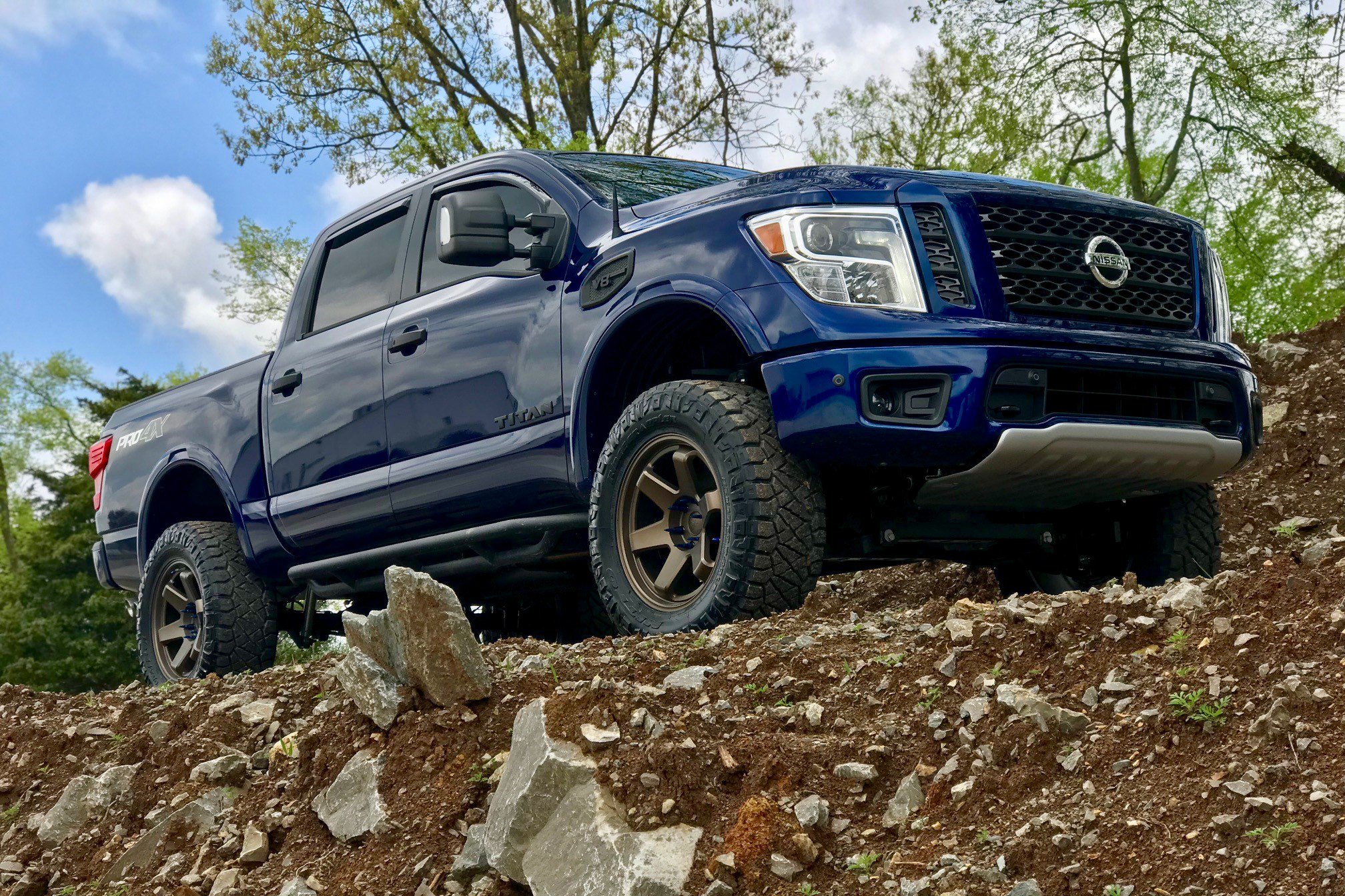 Blue Nissan Titan V8 with Blacked Out Mesh Grille - Photo by Black Rhino Wheels