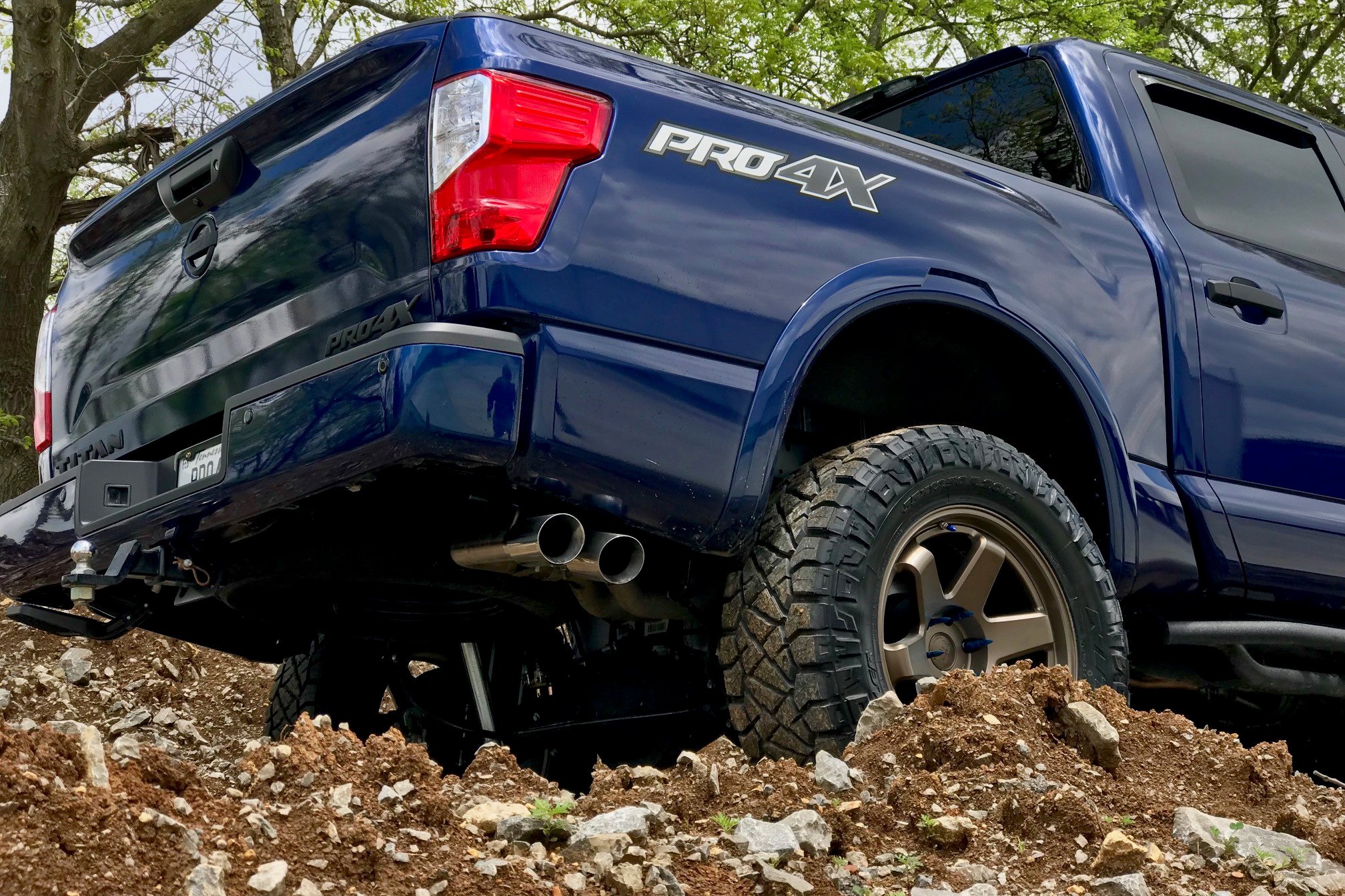 Aftermarket Exhaust System on Blue Nissan Titan V8 - Photo by Black Rhino Wheels