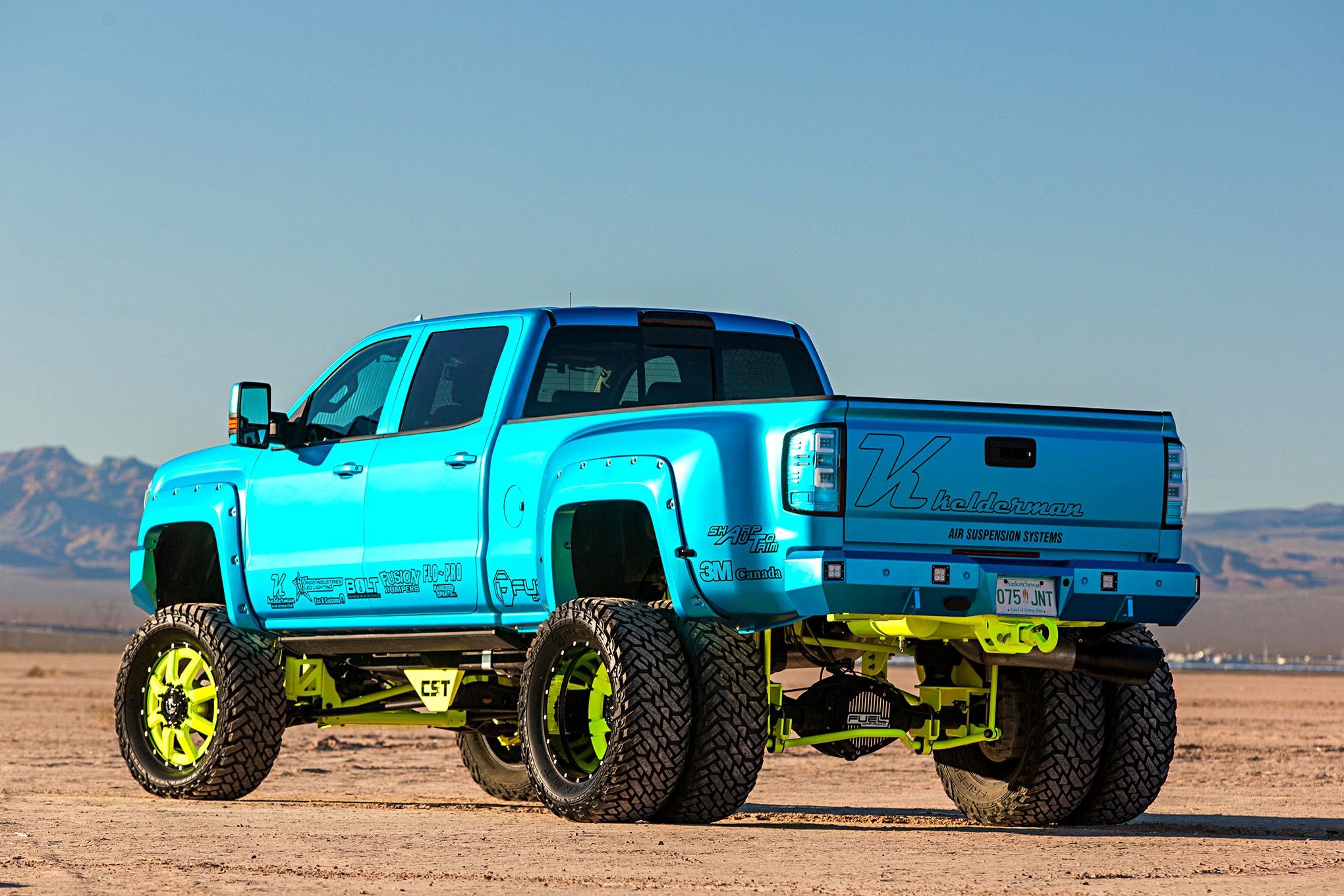 GMC Sierra with candy blue custom paint and neon green CST lift kit - Photo by Cody Gephart (Trucktrend)