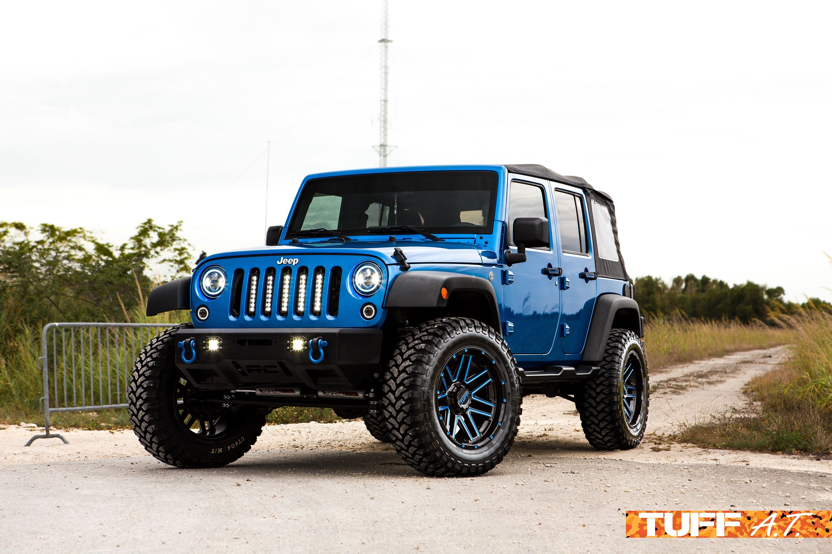 Blue Jeep Wrangler JK Unlimited with soft top - Photo by Tuff