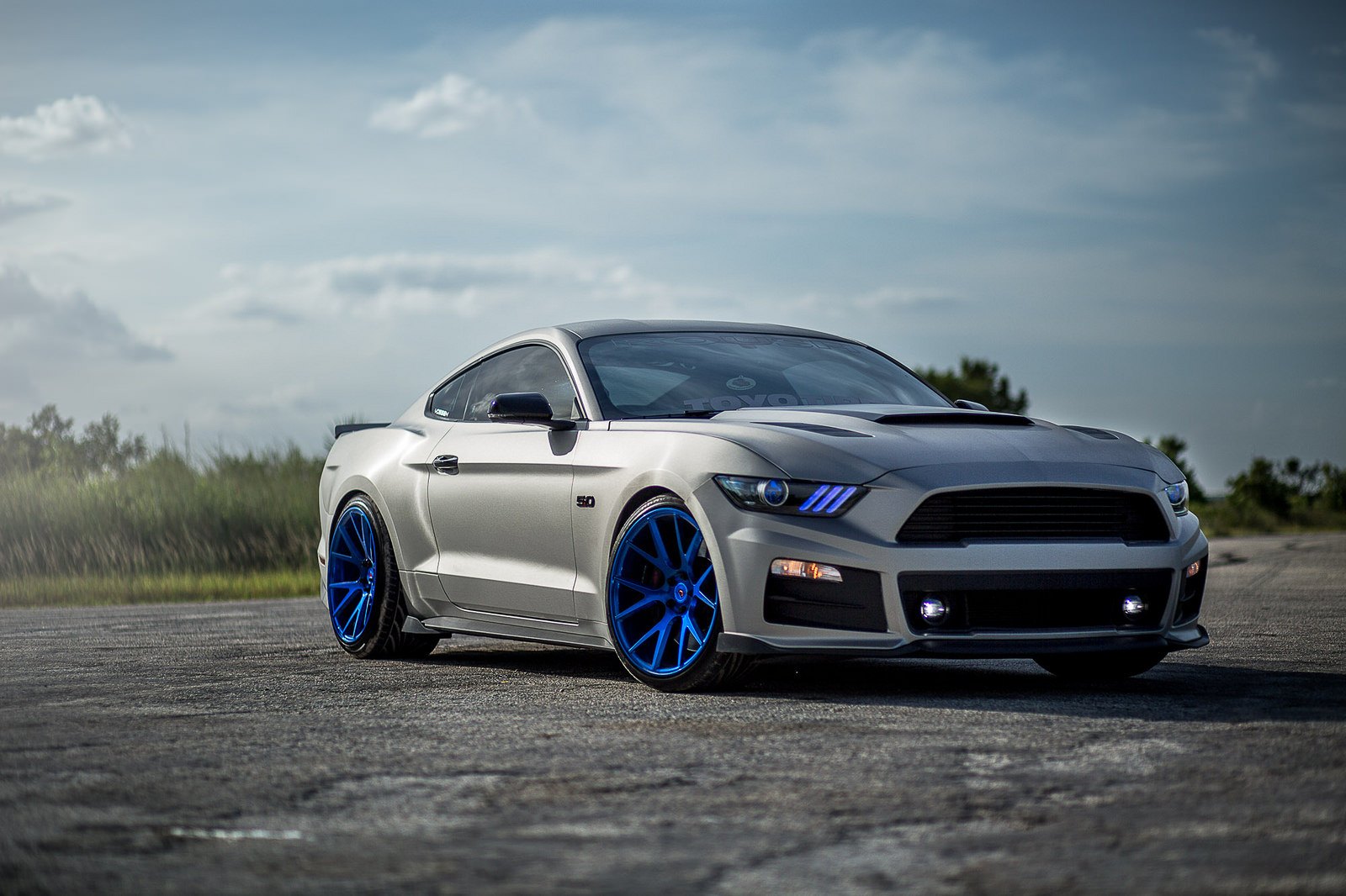 Stanced Ford Mustang 5.0 on Blue custom painted Vossen rims - Photo by Vossen