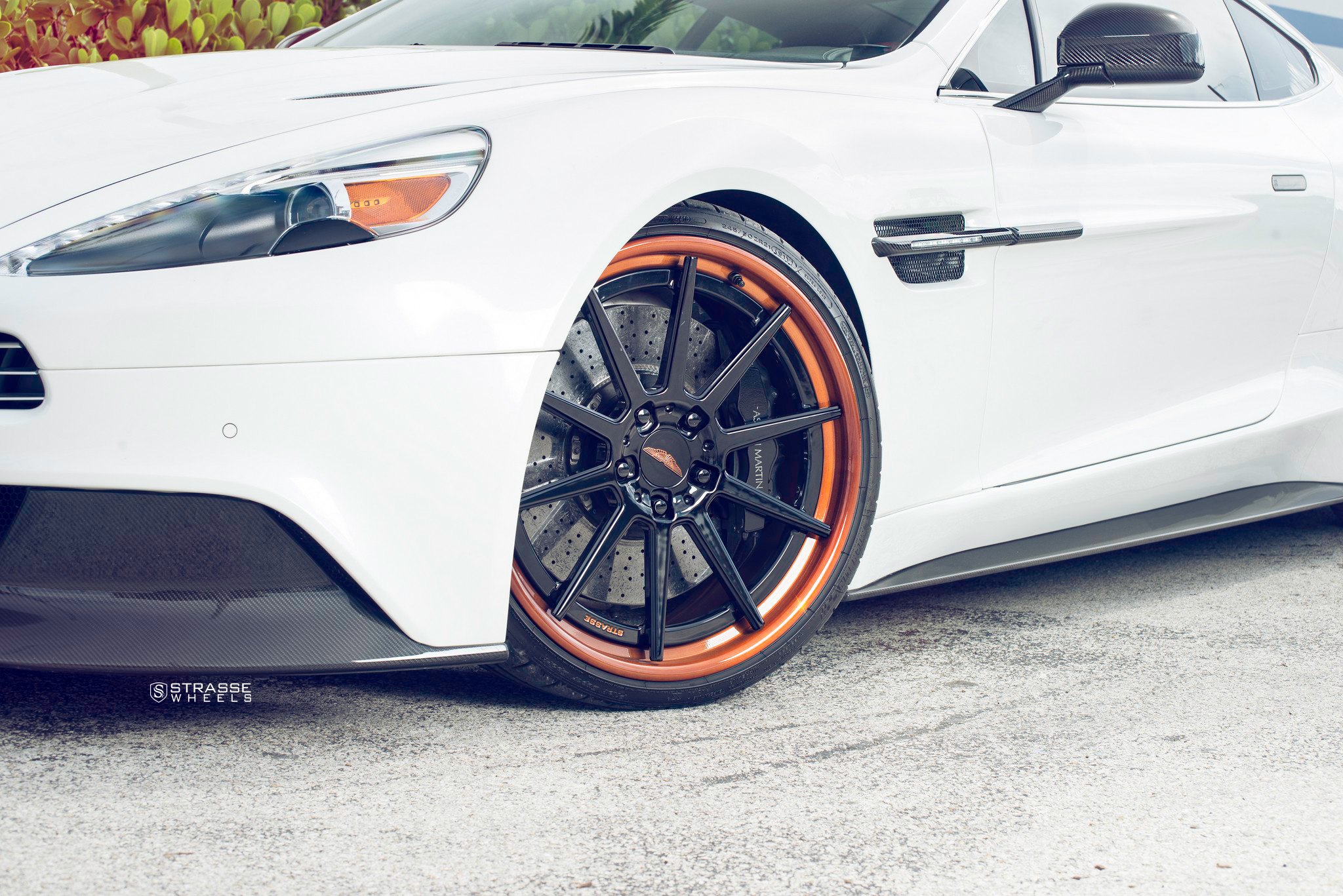 White Aston Martin Vanquish with Aftermarket Projector Headlights - Photo by Strasse Wheels