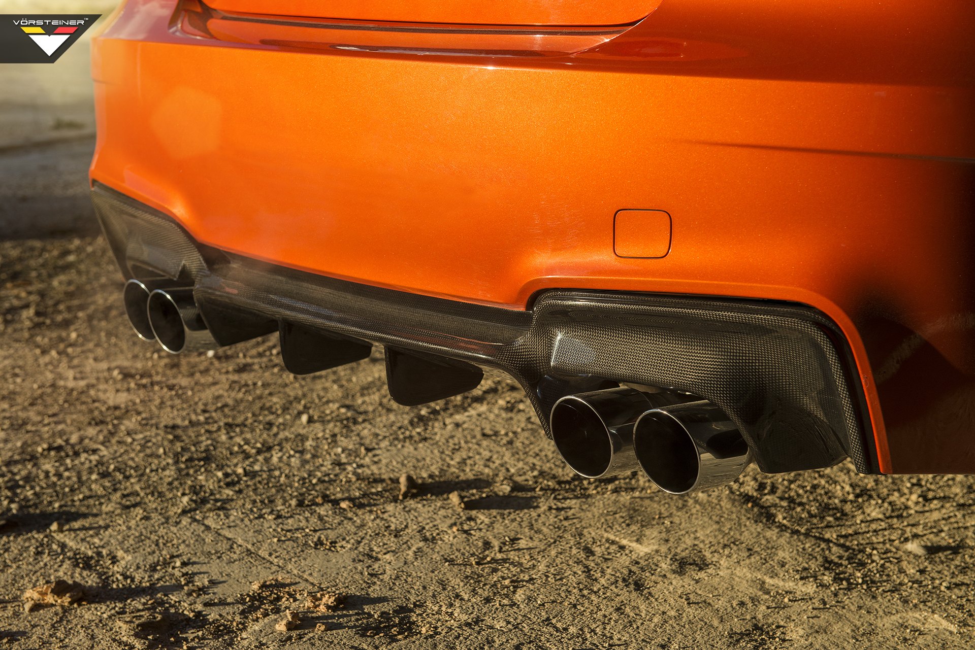Carbon Fiber Rear Diffuser on Orange BMW 1-Series - Photo by Vorstiner