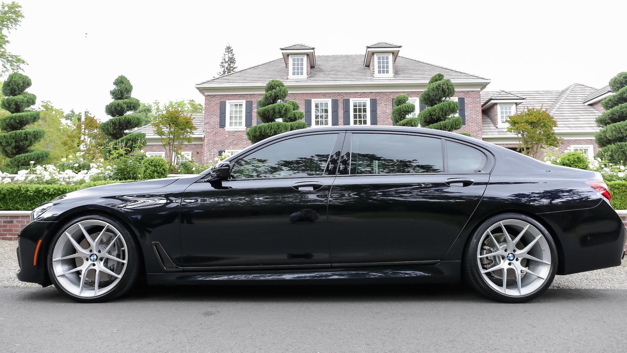 Aftermarket Side Skirts on Black BMW 7-Series - Photo by Forgeline Motorsports