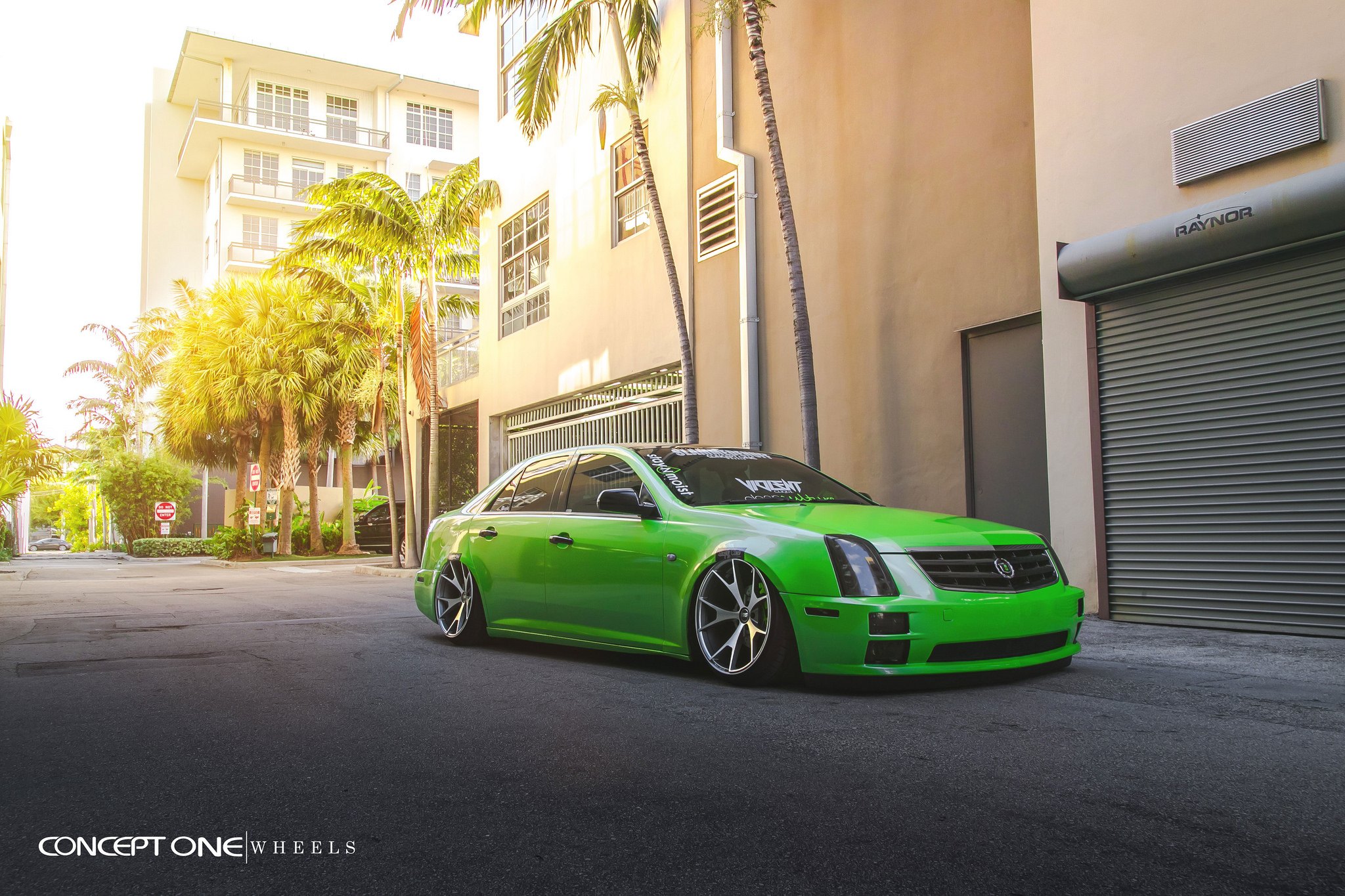 Green Lowered Cadillac STS with Dark Smoke Headlights - Photo by Concept One