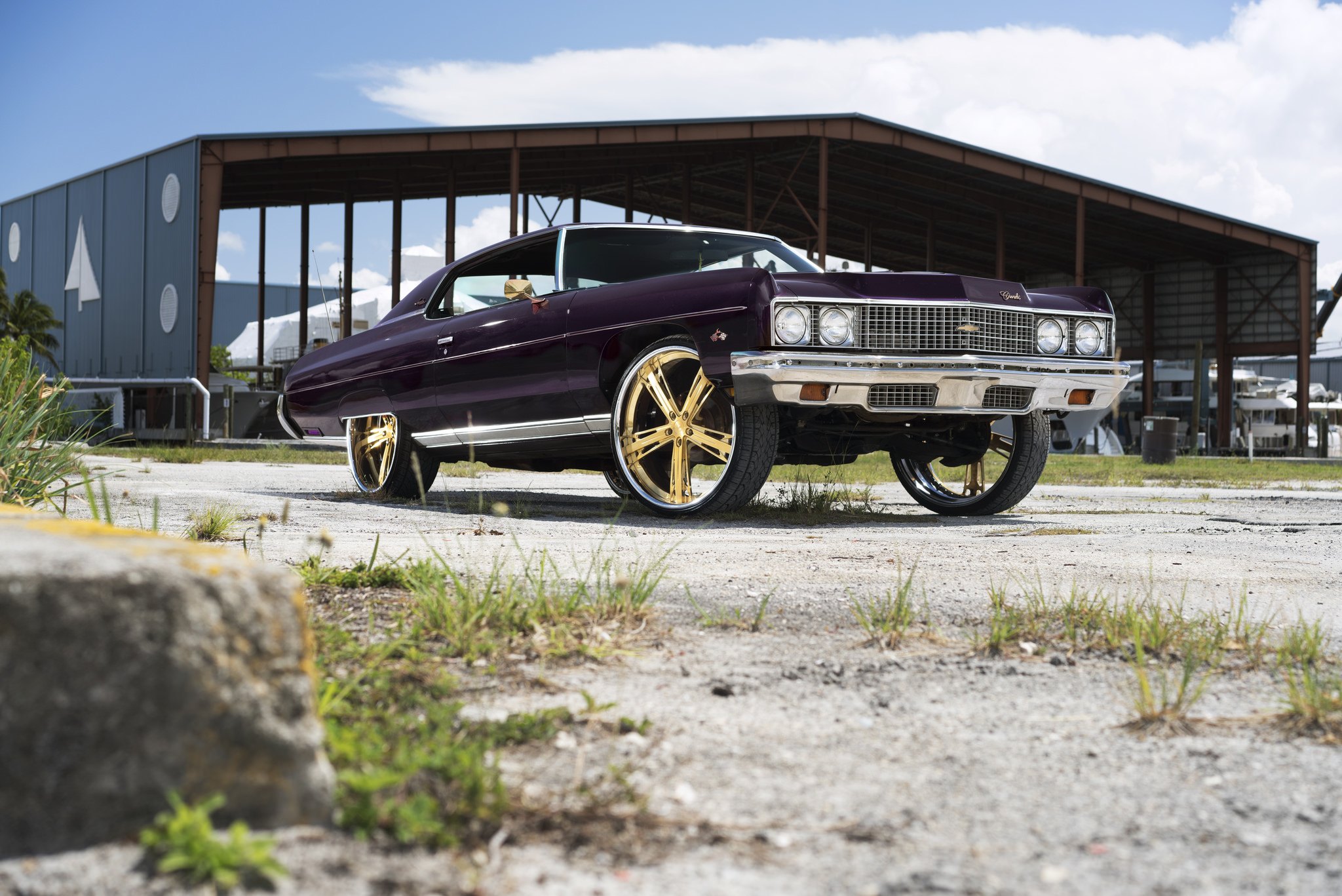 Lifted Purple Chevy Impala on Gold Wheels - Photo by DUB