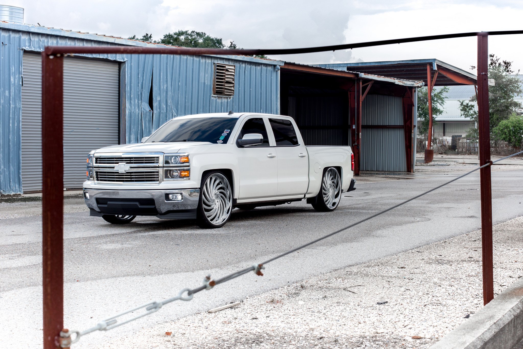 White Chevy Silverado with Aftermarket Projector Headlights - Photo by Dub Wheels