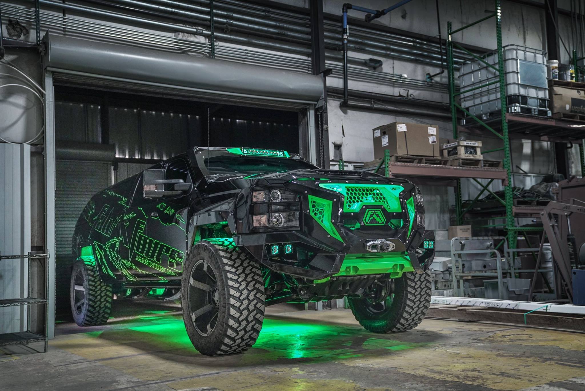 Black Lifted Chevy Silverado with Green Accents - Photo by Fab Fours