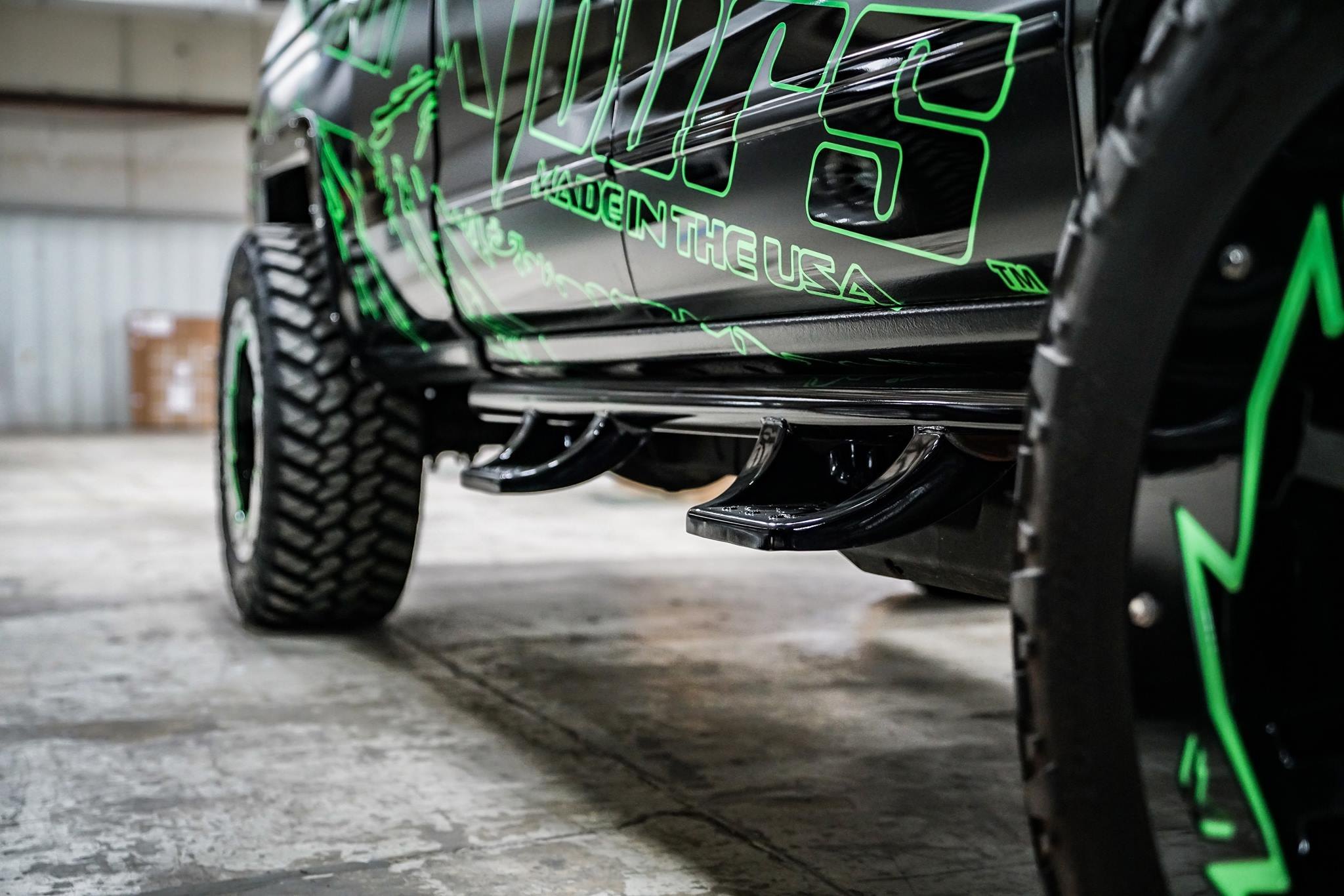 Aftermarket Nerf Steps on Black Lifted Chevy Silverado - Photo by Fab Fours