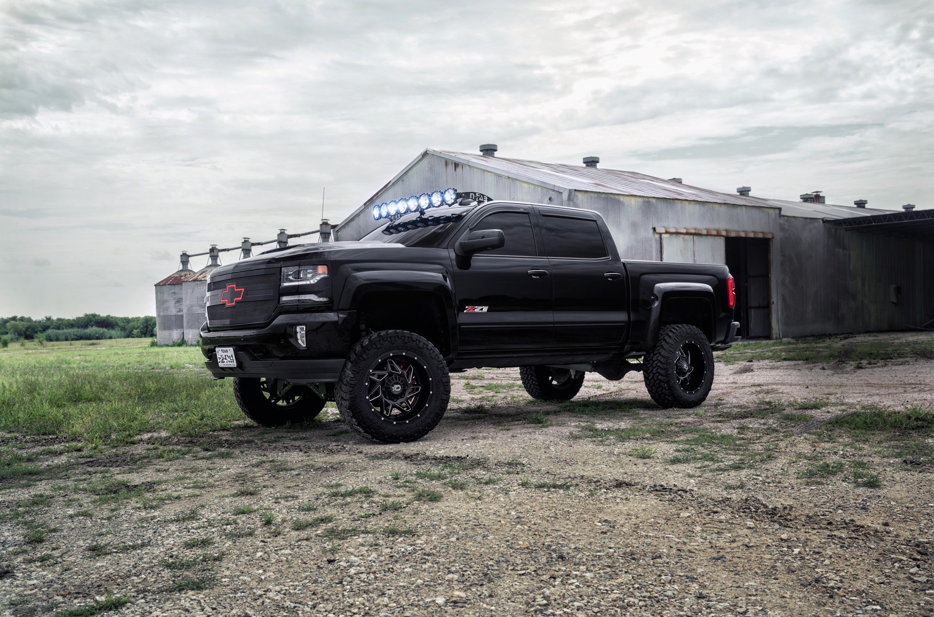 Black Lifted Chevy Silverado with KC HiLiTES Lights - Photo by Dropstar