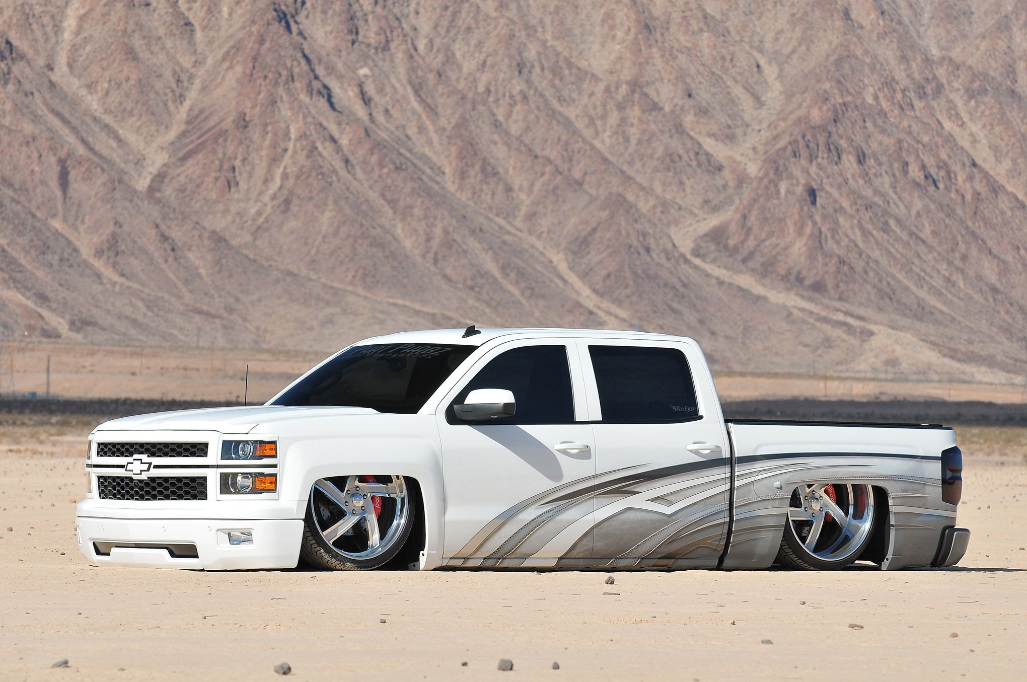 White Lowered Chevy Silverado with Custom Chrome Wheels - Photo by Phil Gordon