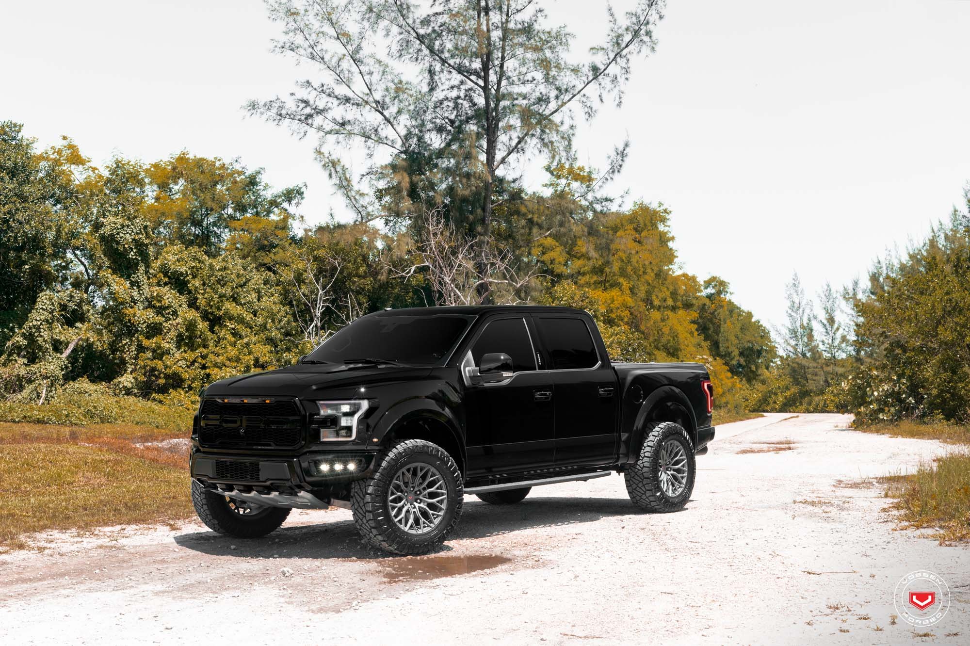 Black Lifted Ford F-150 with Custom Projector Headlights - Photo by Vossen