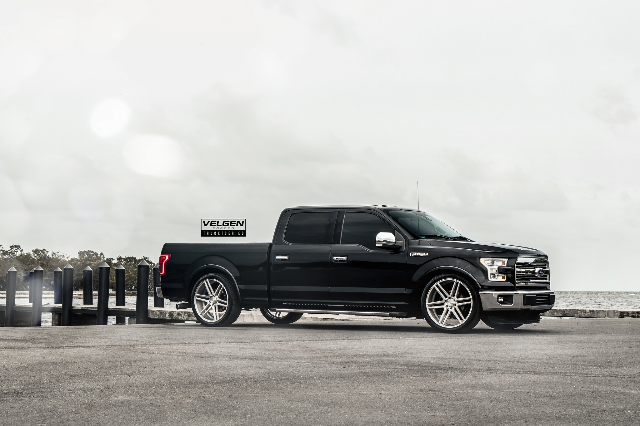 Black Ford F-150 Lariat with Chrome Side Mirrors - Photo by Velgen