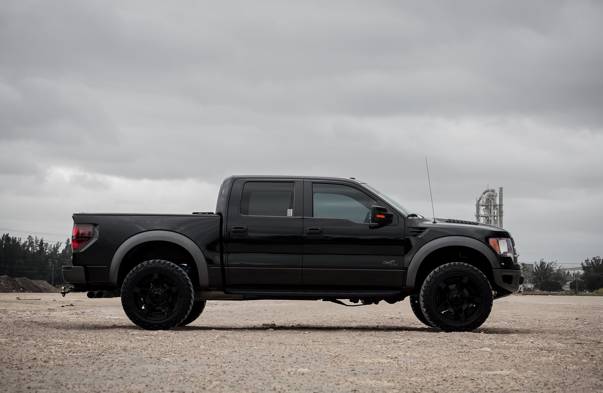 Lifted Raptor On black Off-road Wheels - Photo by Exclusive Motoring