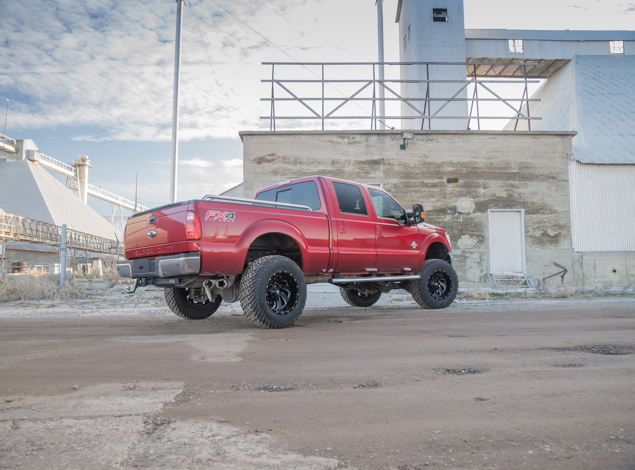 Red Lifted Ford F-250 with Bed Rails - Photo by Fuel Offroad