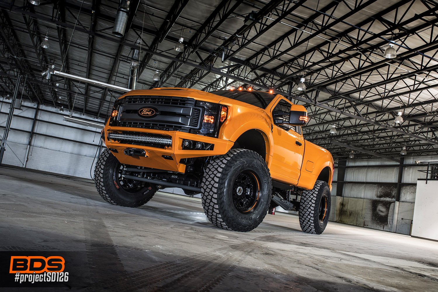 Dark Smoke Headlights on Orange Lifted Ford F-250 - Photo by BDS Suspension