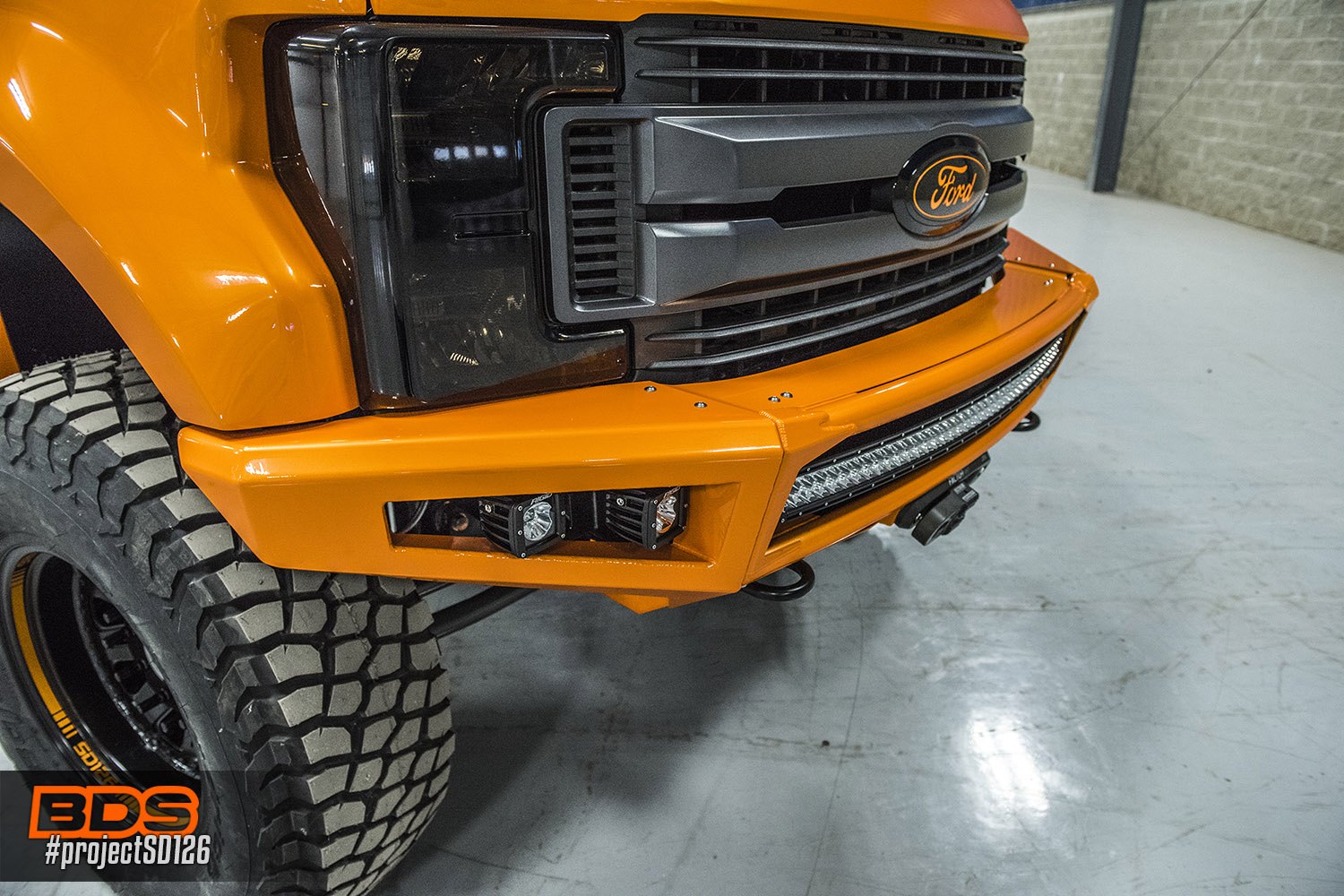 Rigid LED Off-Road Lights on Orange Lifted Ford F-250 - Photo by BDS Suspension