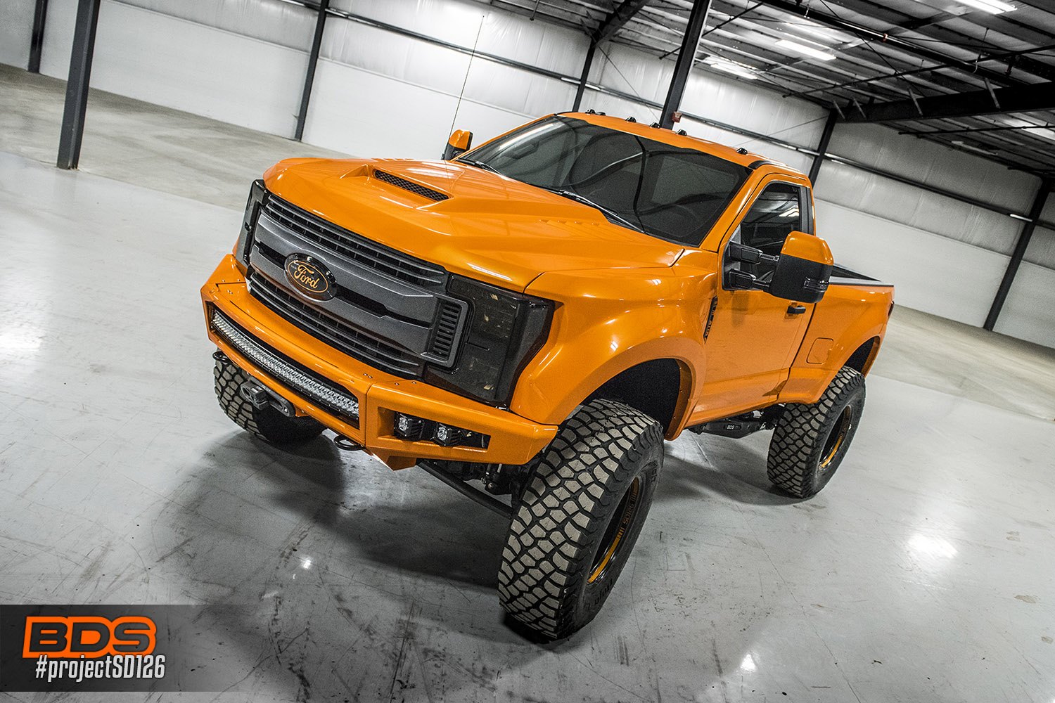 Orange Lifted Ford F-250 with Custom Vented Hood - Photo by BDS Suspension