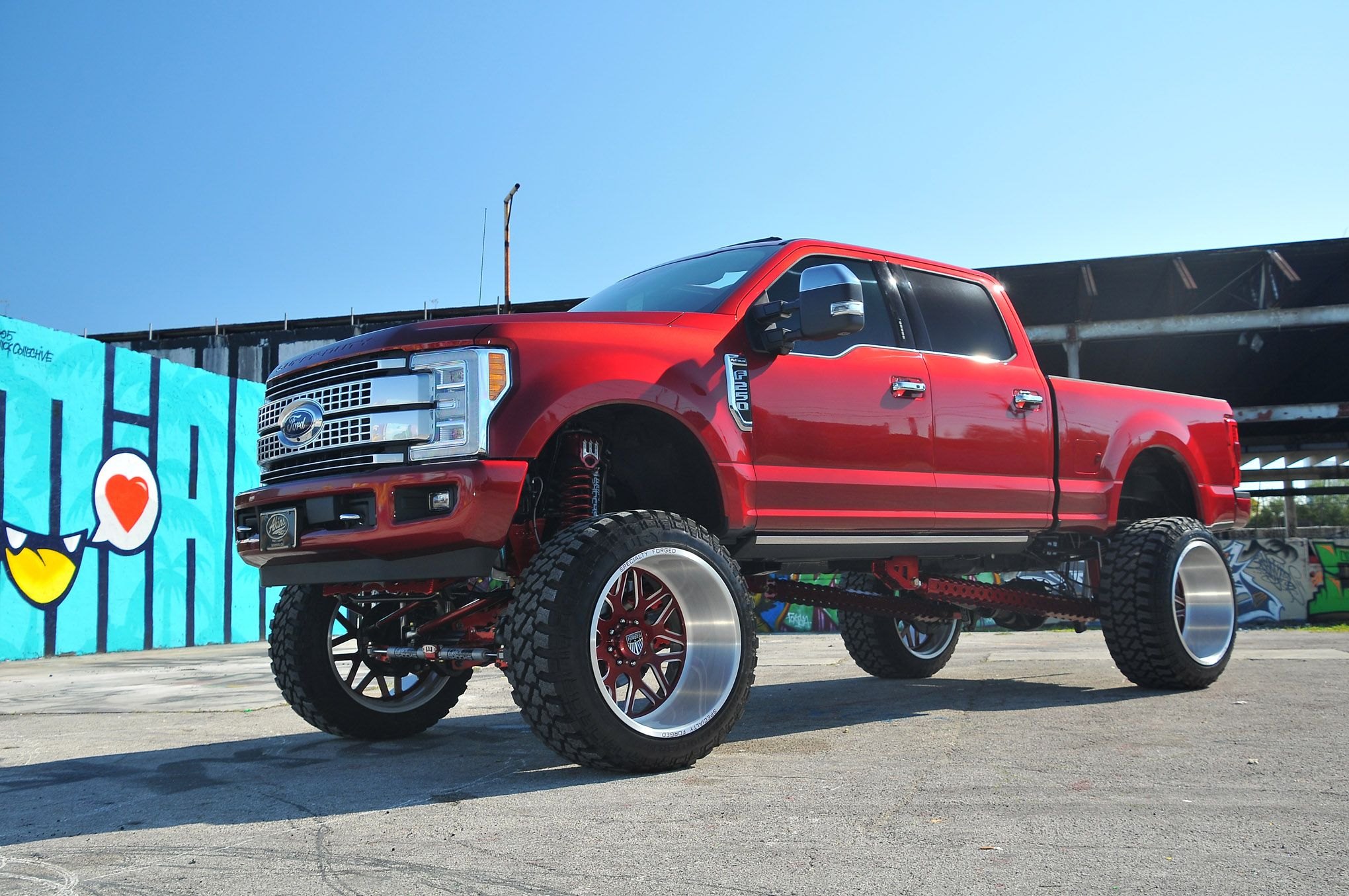 Red Lifted Ford F-250 with Aftermarket Headlights - Photo by Phil Gordon