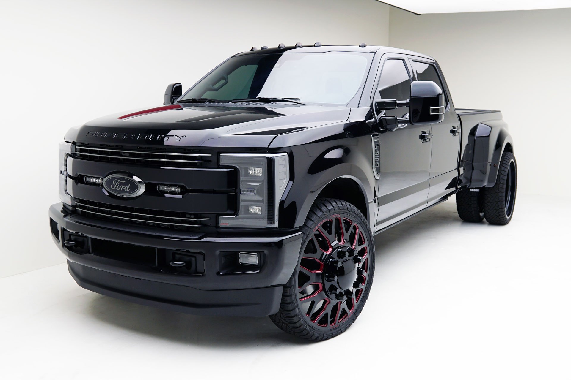 Black Ford F350 With Black Grille And Custom Painted Rims - Photo by MAD Industries