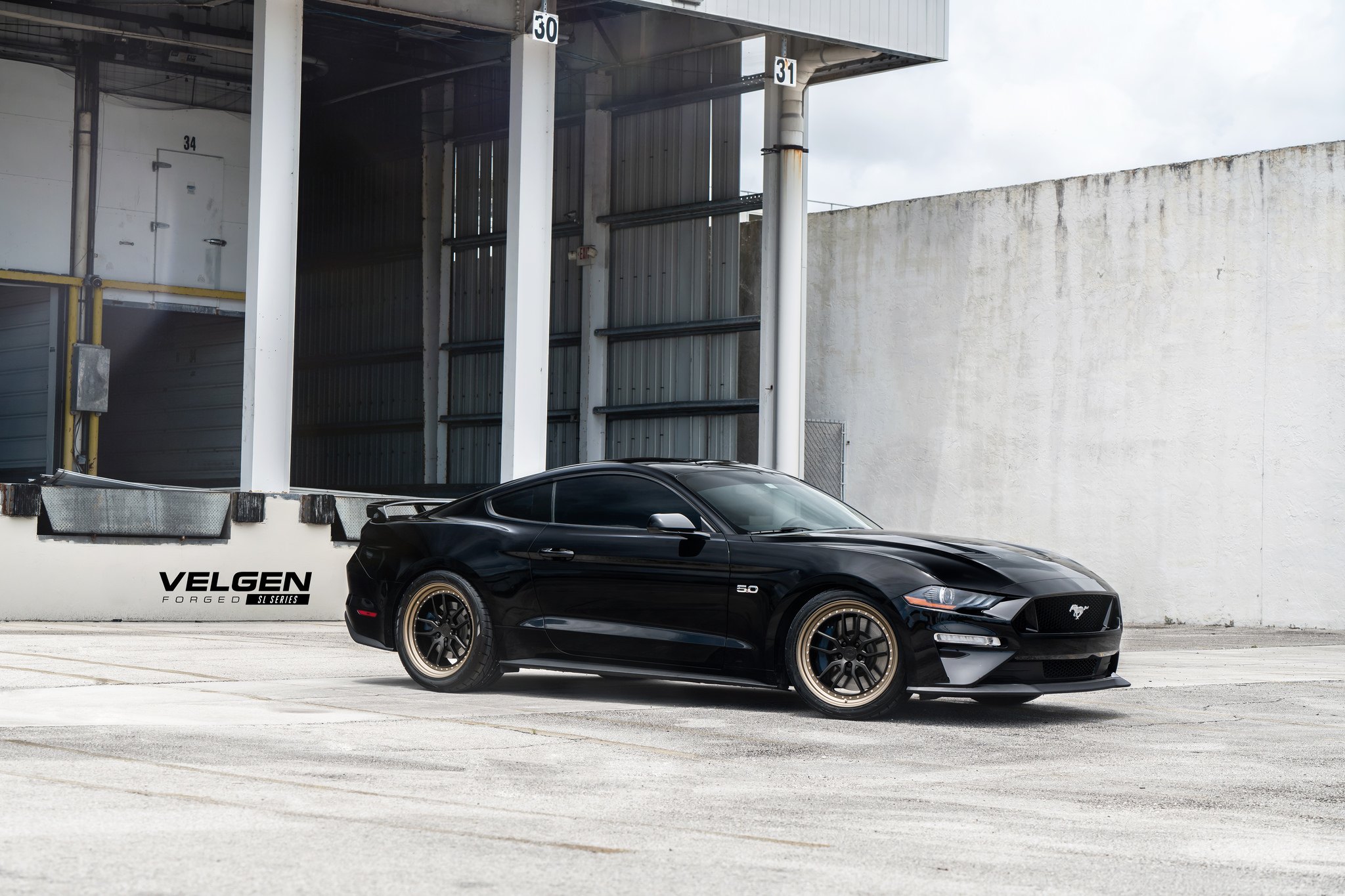 Aftermarket Side Skirts on Black Ford Mustang - Photo by Velgen Wheels