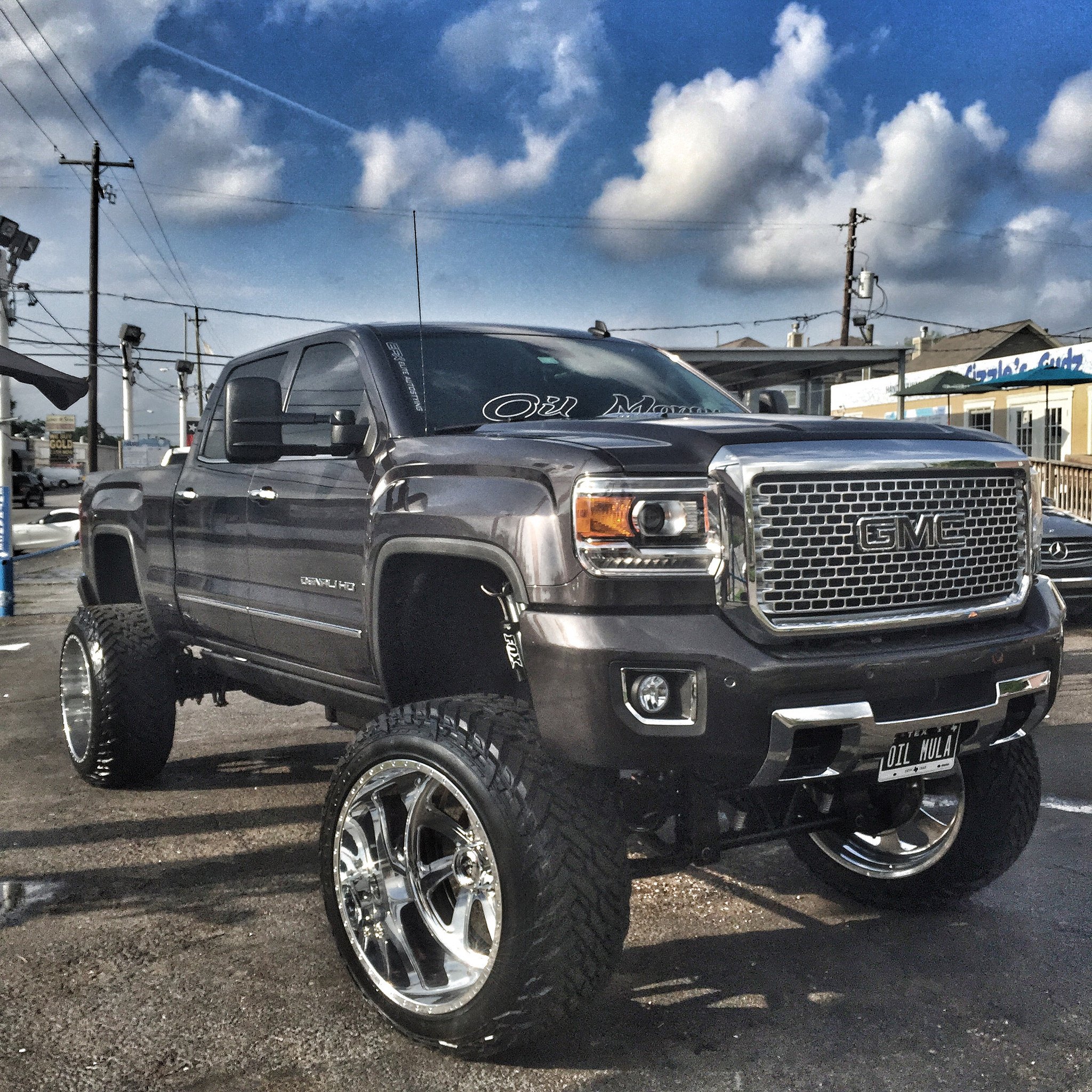 Black Lifted GMC Sierra Denali HD with Chrome Grille - Photo by Fuel Offroad