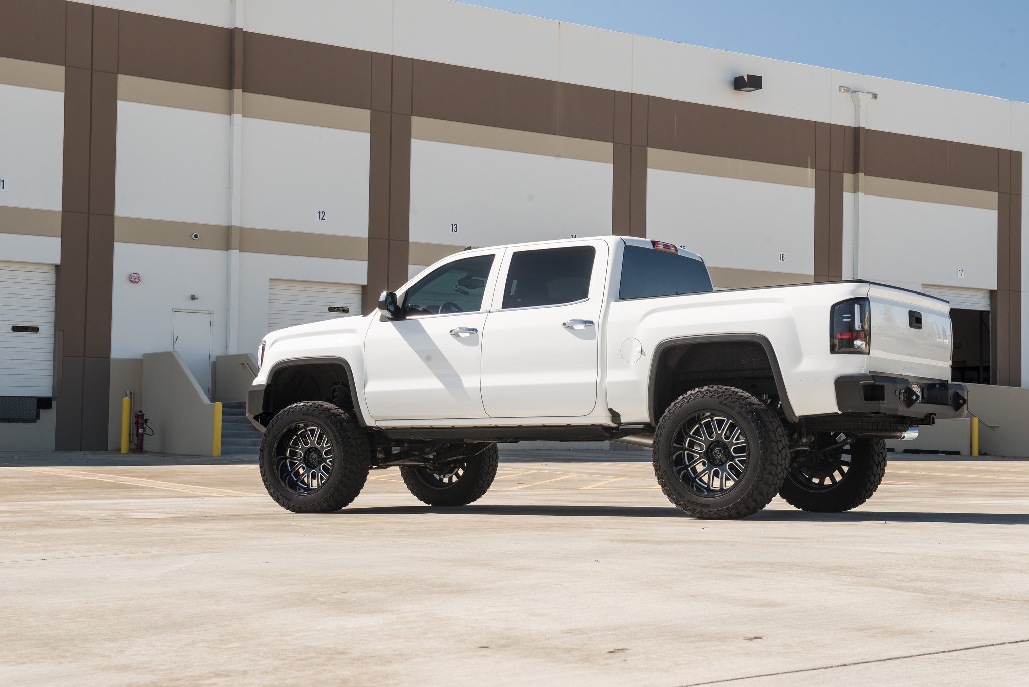 Retractable Running Boards on White Lifted GMC Sierra - Photo by Black Rhino Wheels