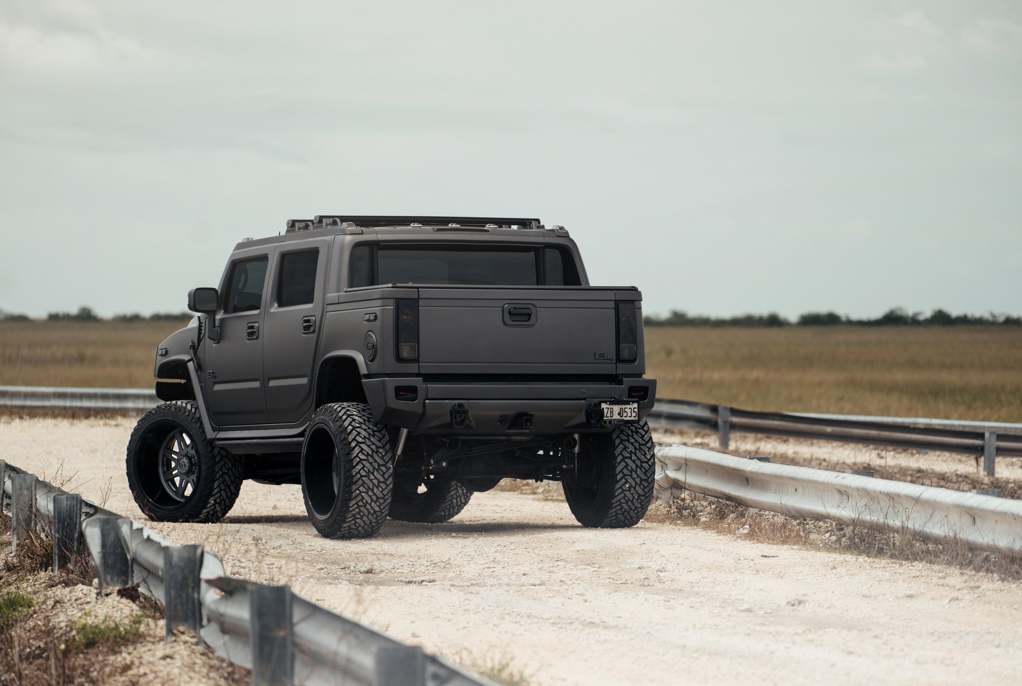 Dark Smoke Taillights on Black Matte Hummer H2 - Photo by Fuel Offroad