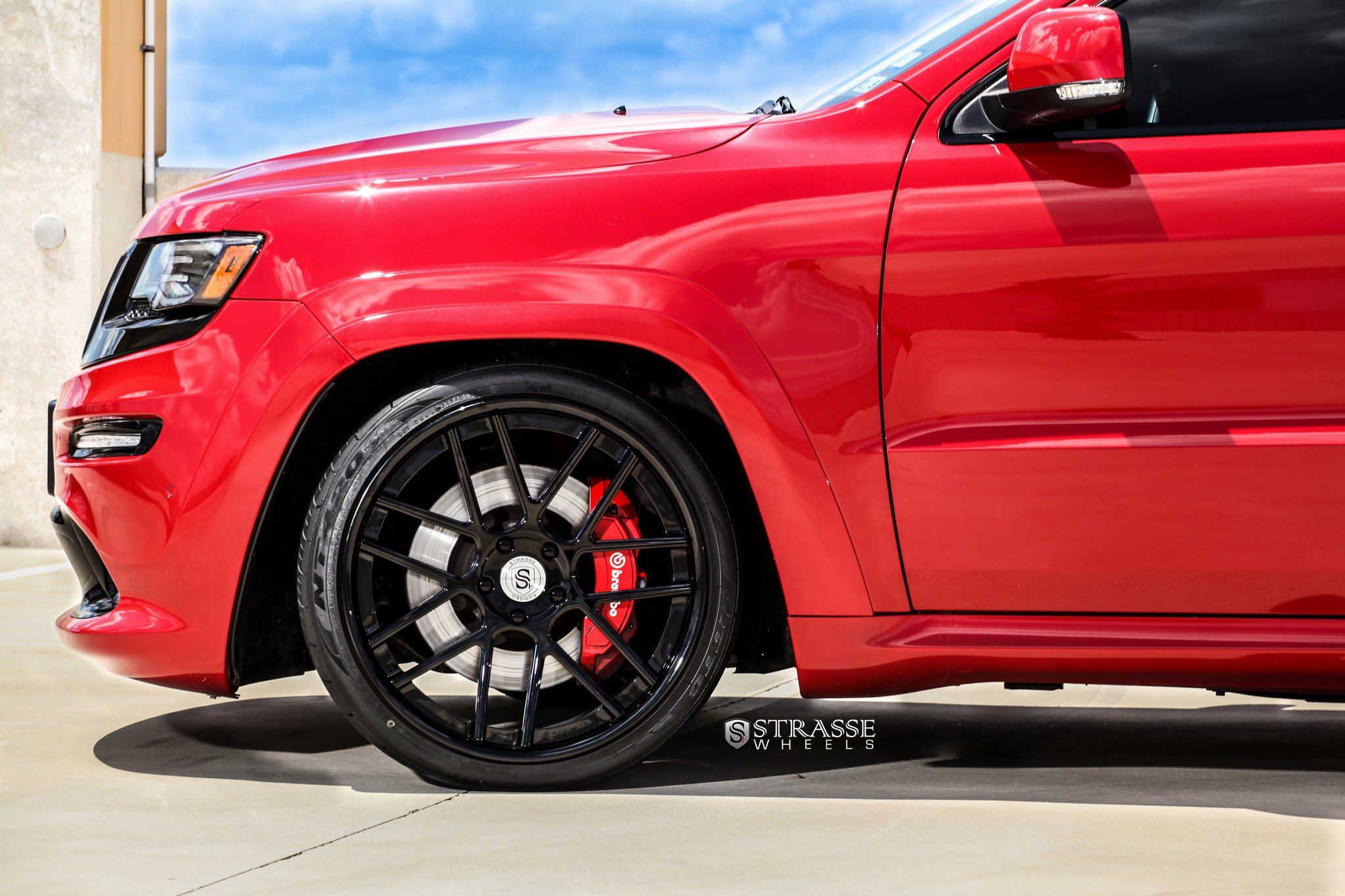 Aftermarket Side Skirts on Red Jeep Grand Cherokee - Photo by Strasse Forged