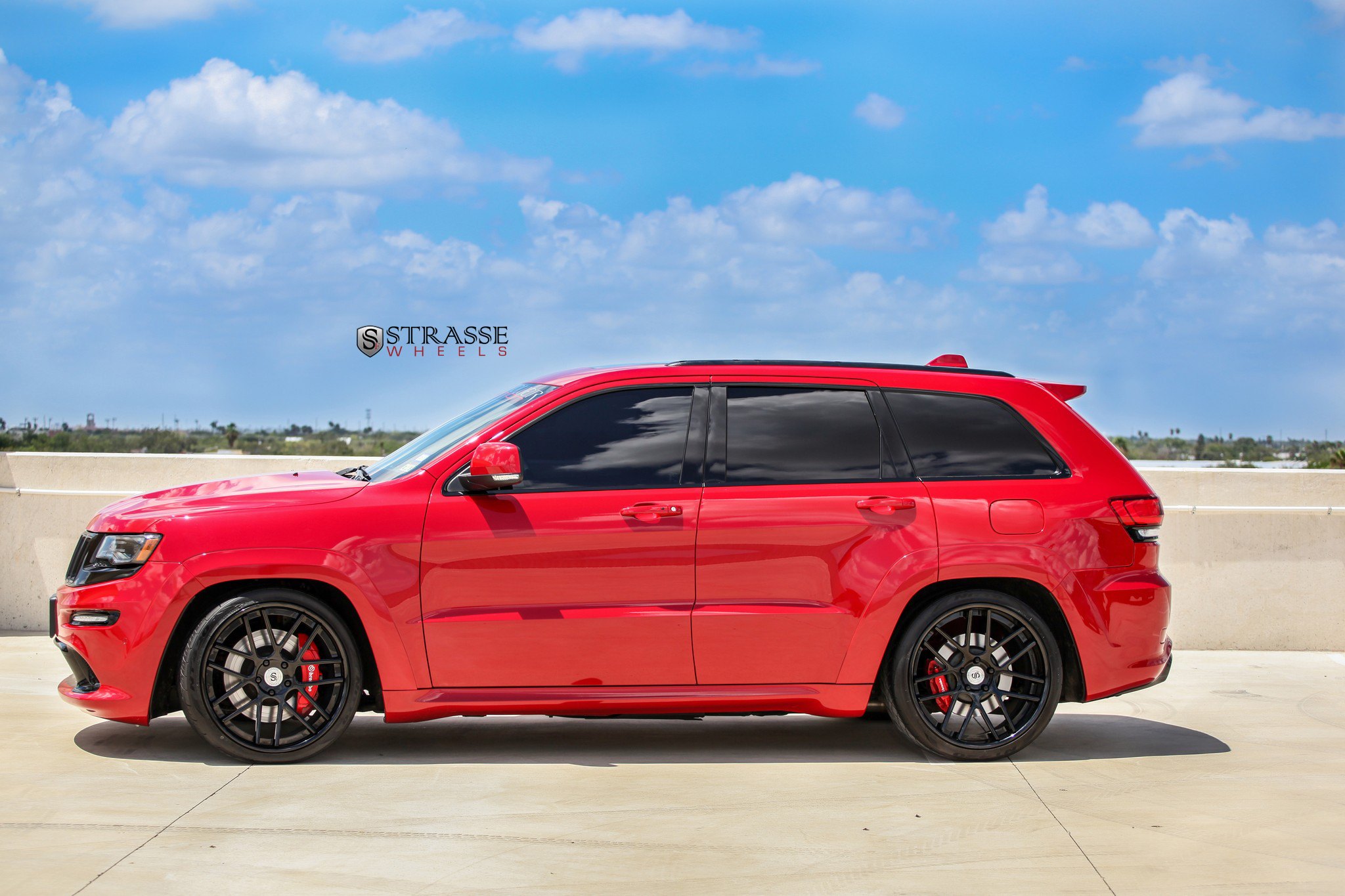 Gloss Black Strasse Wheels on Red Jeep Grand Cherokee - Photo by Strasse Forged