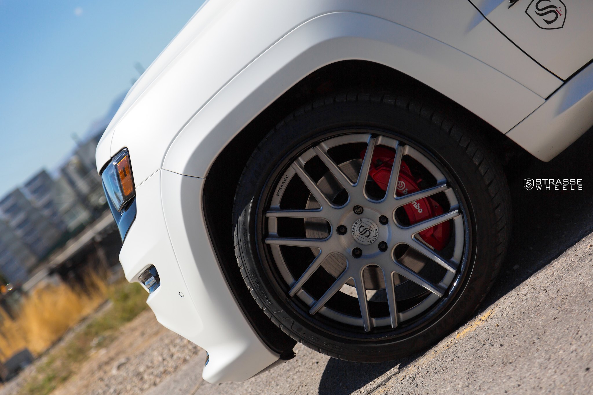 Brushed Titanium Strasse Rims on White Jeep Grand Cherokee - Photo by Strasse Forged