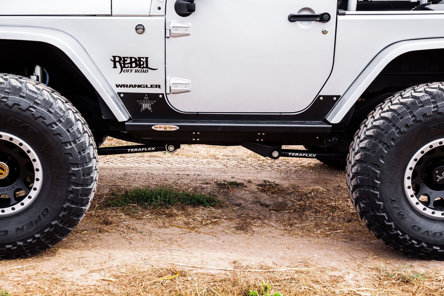 White Lifted Jeep Wrangler with Rock Slide Running Boards - Photo by Rebel Off-Road