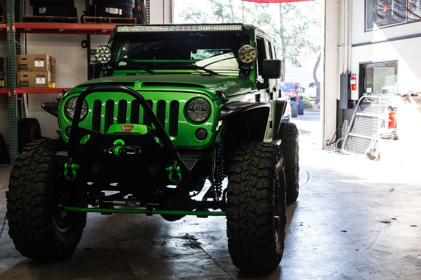 Green Lifted Jeep Wrangler with Custom Vented Hood - Photo by Rebel Off-Road