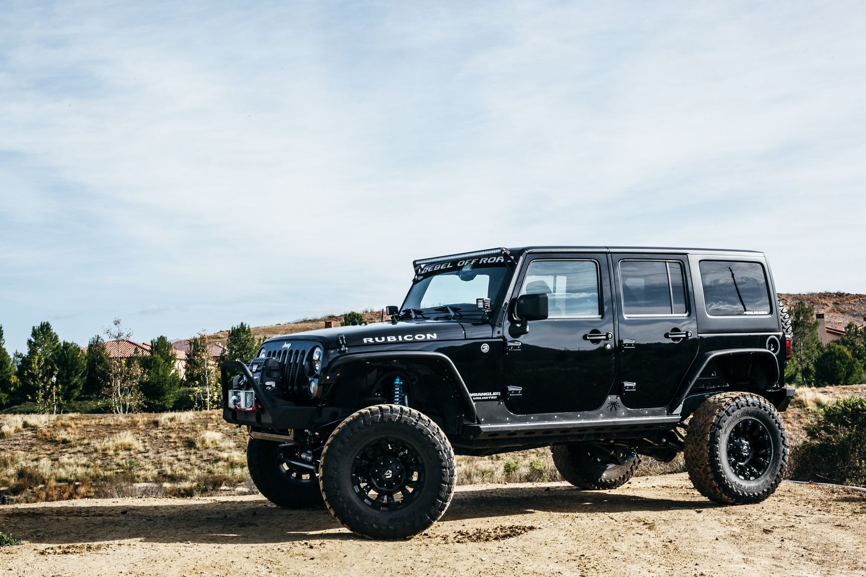 Black Lifted Jeep Wrangler with Poison Spyder Running Boards - Photo by Rebel Off-Road
