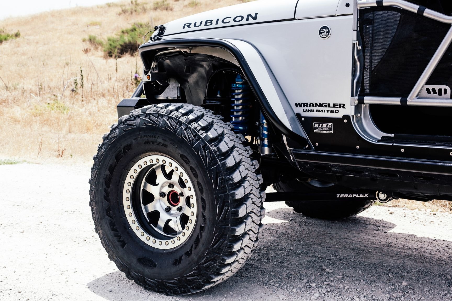 Chrome Raceline Wheels on Gray Lifted Jeep Wrangler - Photo by Rebel Off-Road