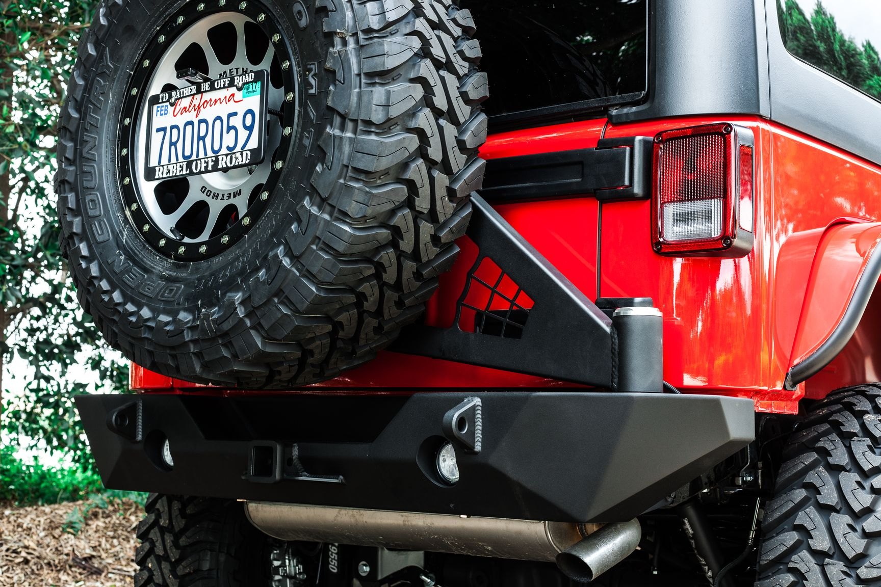 Red Jeep Wrangler with Poison Spyder Spare Tire Kit - Photo by Rebel Off-Road