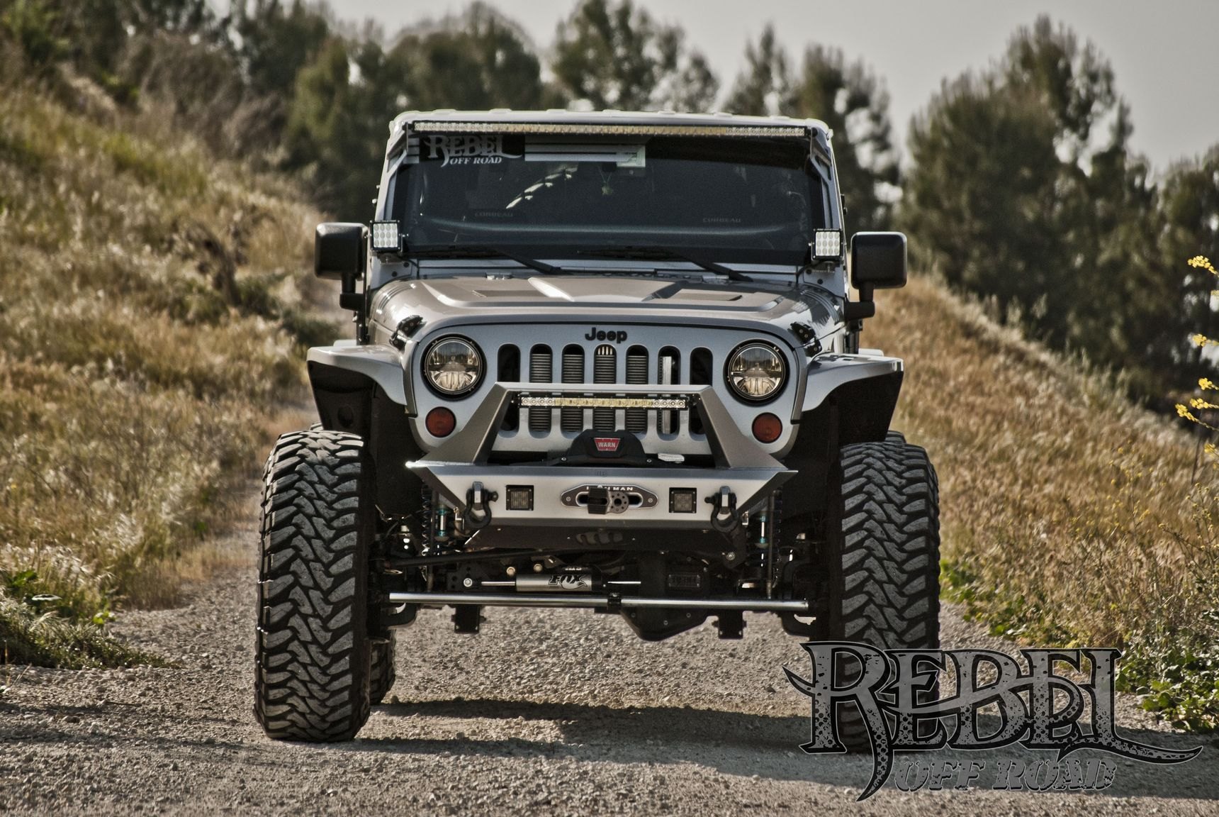 Gray Lifted Jeep Wrangler with Custom Headlights - Photo by Rebel Off-Road