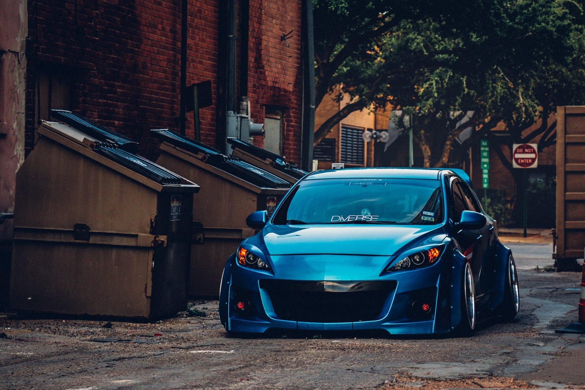 Aftermarket Halo Headlights on Blue Mazda 3 - Photo by Clinched