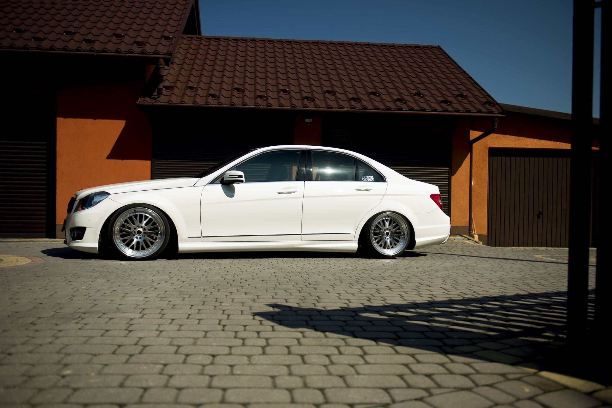 Aftermarket Side Skirts on White Mercedes C Class - Photo by JR Wheels