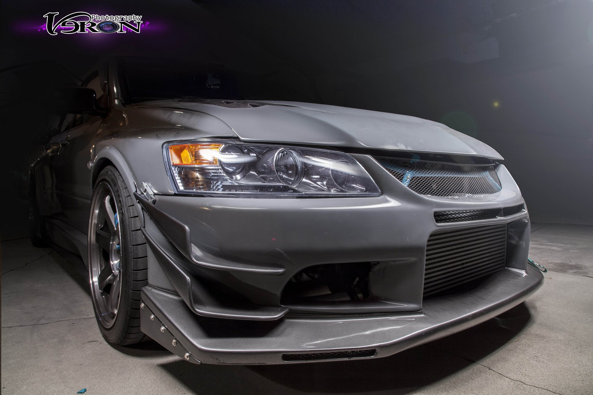 Gray Mitsubishi Evolution with Custom Projector Headlights  - Photo by Manuel veron