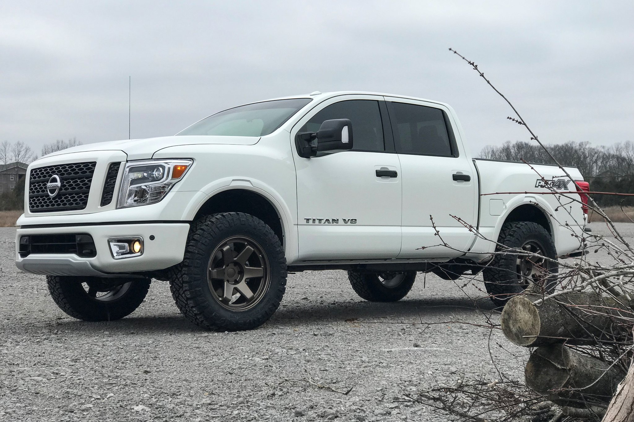 White Nissan Titan V6 with Aftermarket Front Bumper - Photo by TSW Alloy Wheels