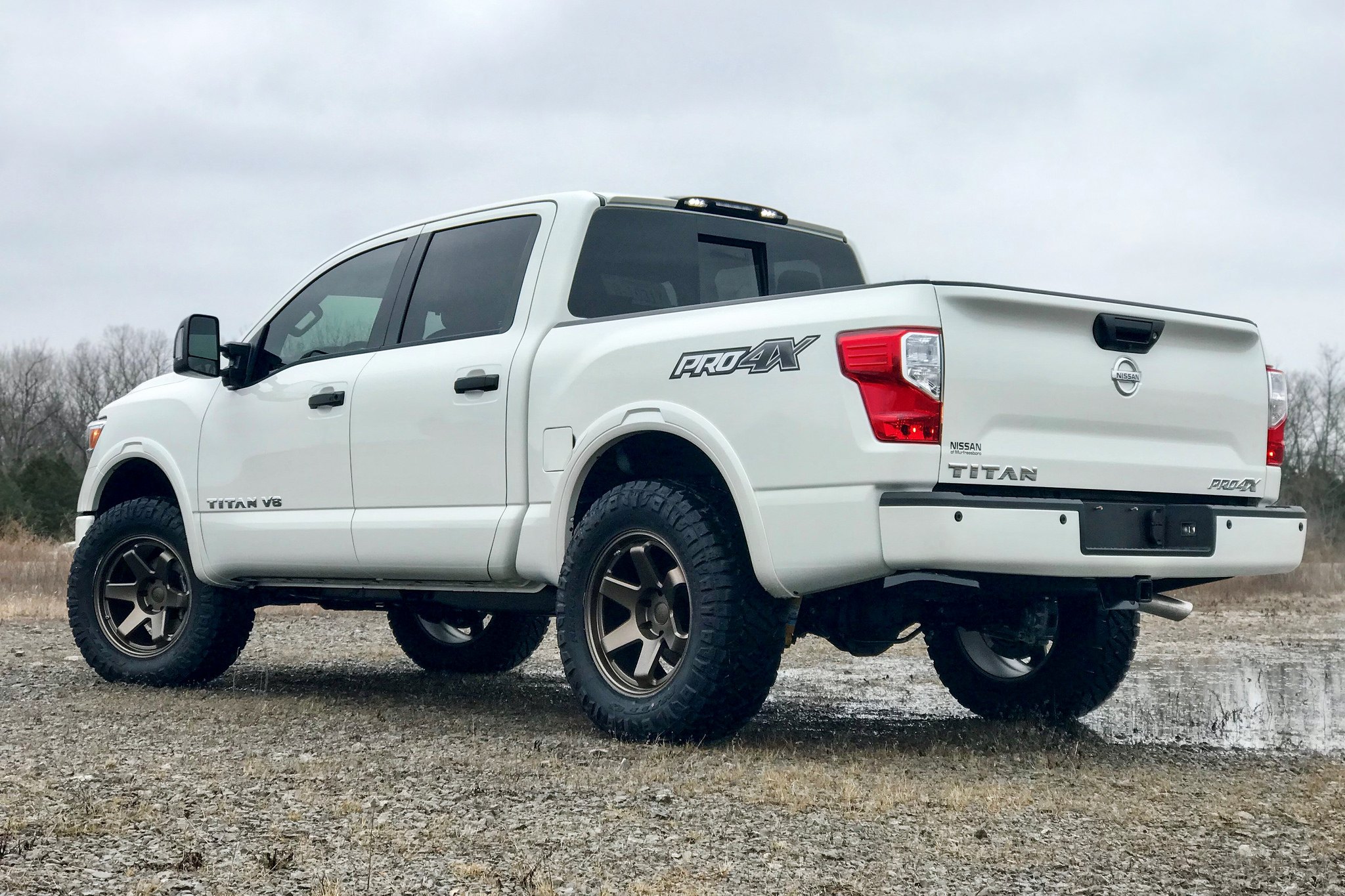 White Nissan Titan with Aftermarket Red LED Taillights - Photo by TSW Alloy Wheels