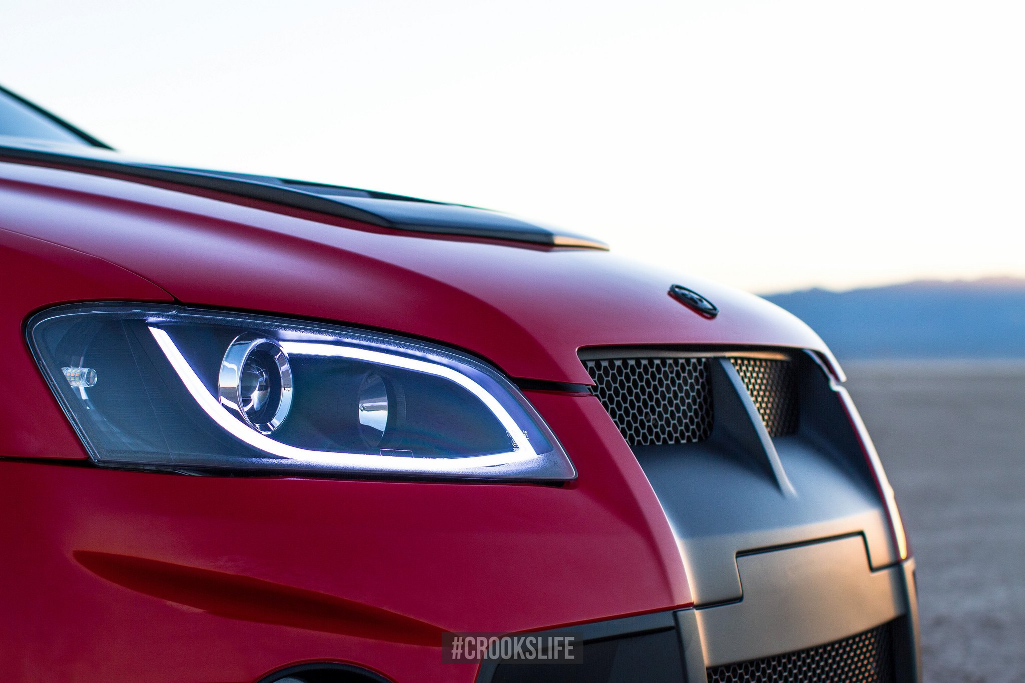 Aftermarket Headlights with LED-Bars on Red Pontiac G8 - Photo by Jimmy Crook