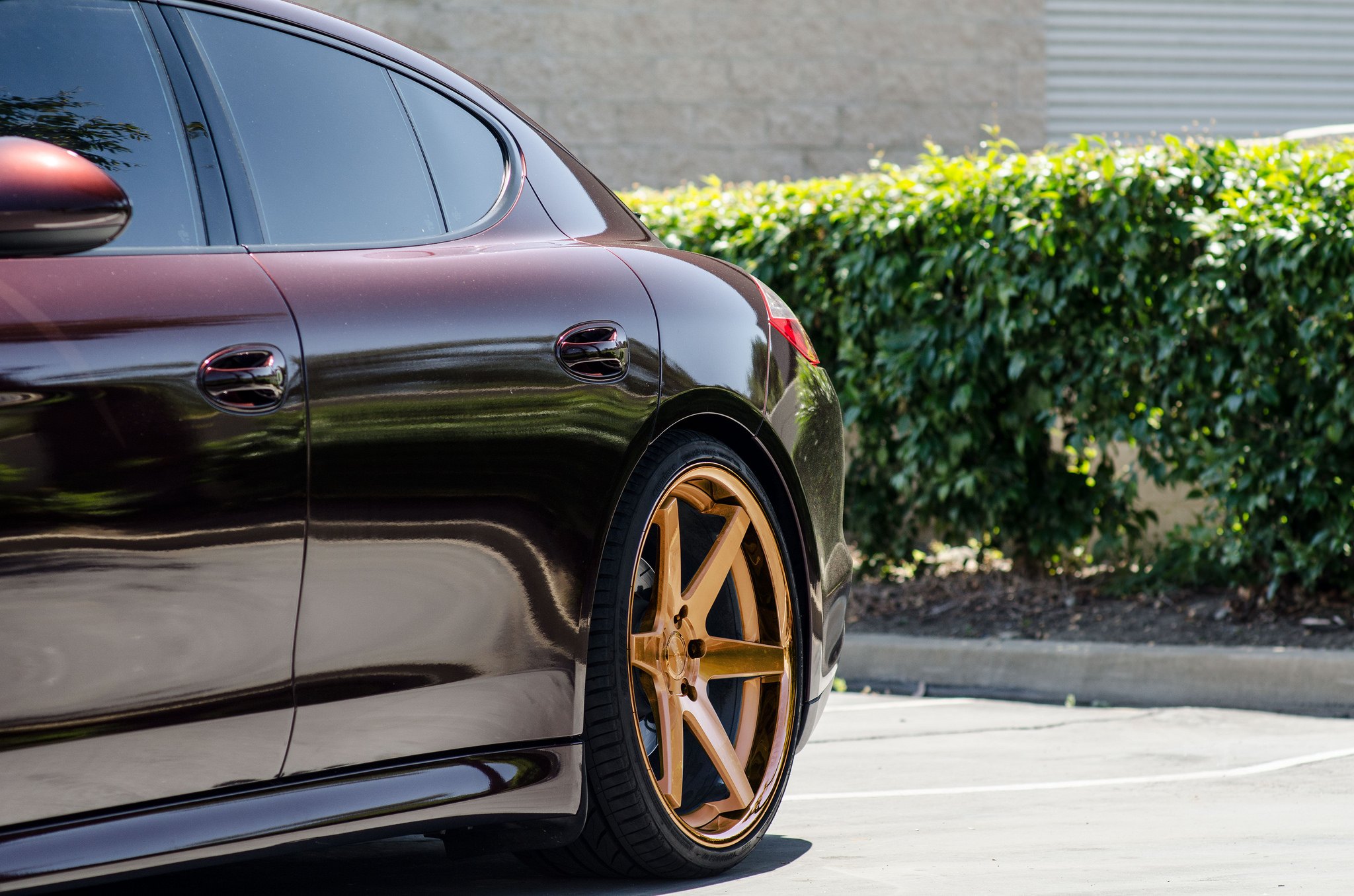 Dark Red Porsche Panamera with Aftermarket Side Skirts - Photo by Concept One