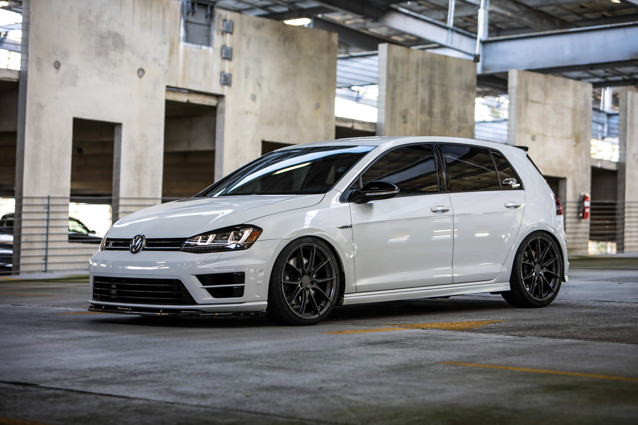 White VW Golf with Aftermarket Headlights - Photo by TSW Wheels